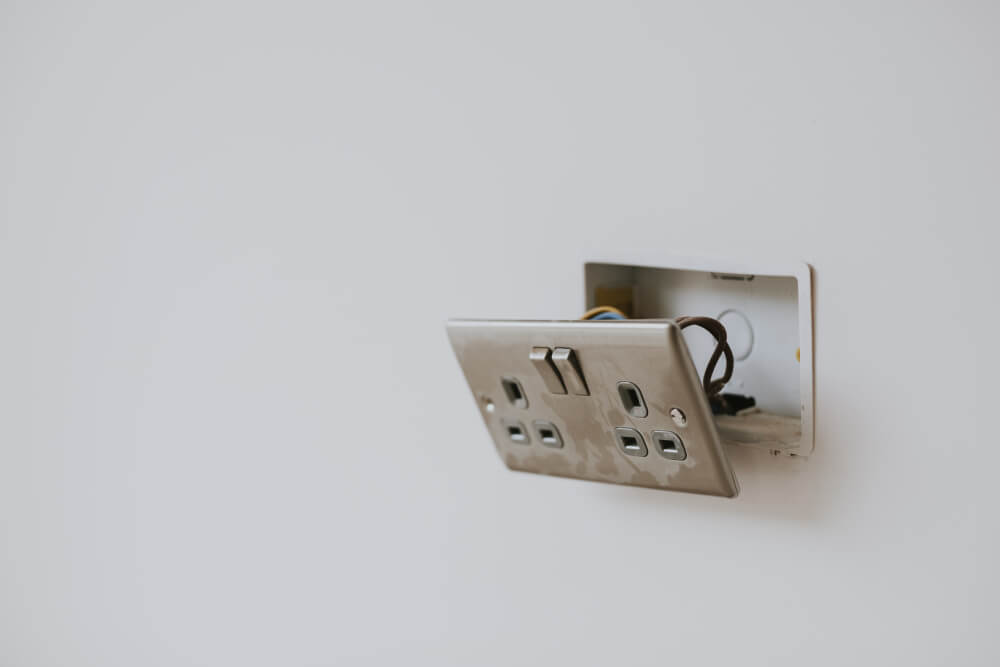 uk main dual plug socket that has come away from the wall, showing wires - SMI Handyman Leeds, Horsforth