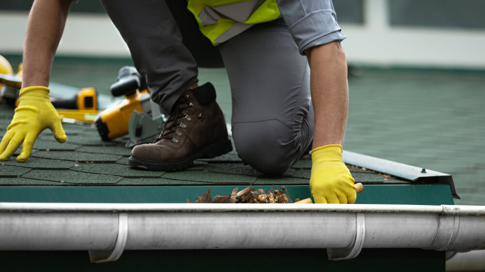 handyman cleaning a gutter - SMI Handyman Leeds, Horsforth