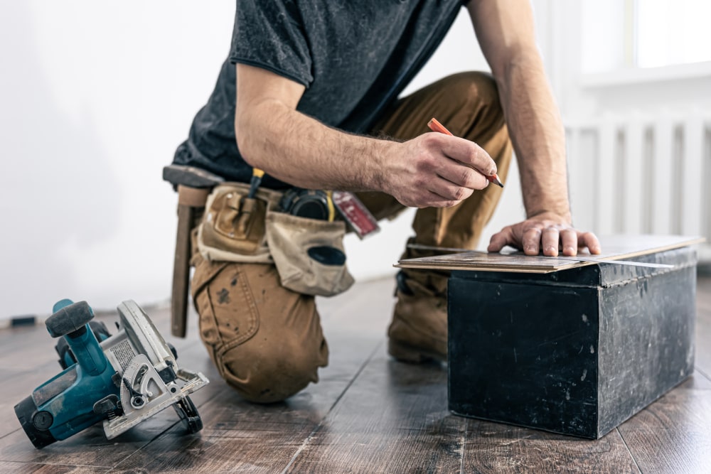 handyman at work with circular saw and other tools